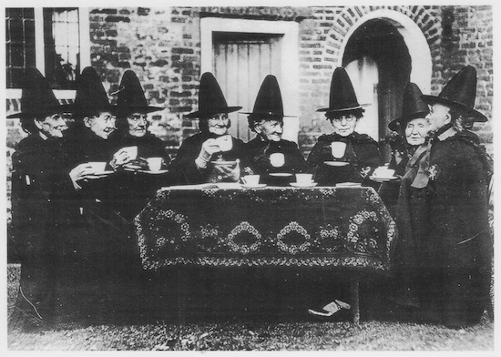 women in hats around table